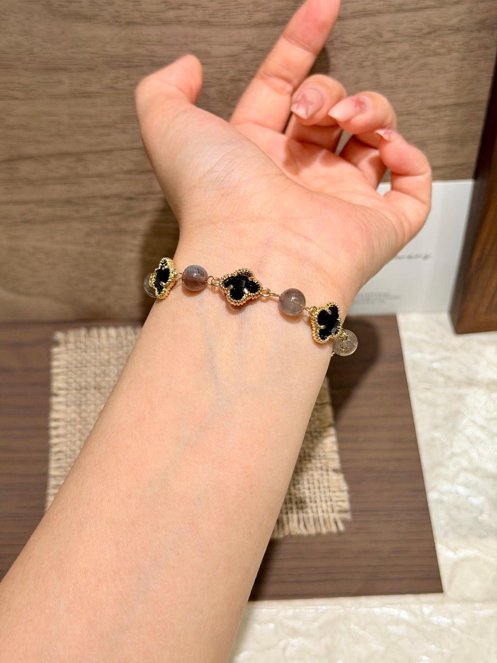 Black Radiance gray moonstone four-leaf clover bracelet on wrist