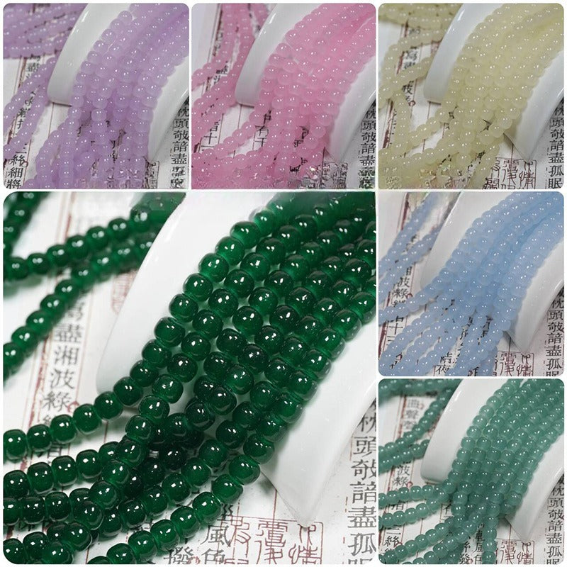 Collage of glazed glass drum bead strands in purple, pink, yellow, green and blue draped over white spools