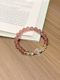 Strawberry quartz bracelet with citrine and white crystal worn on wrist