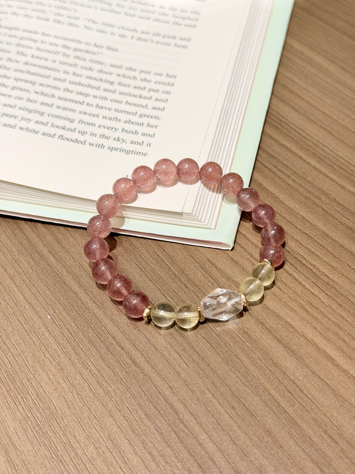Strawberry quartz bracelet with citrine and white crystal worn on wrist