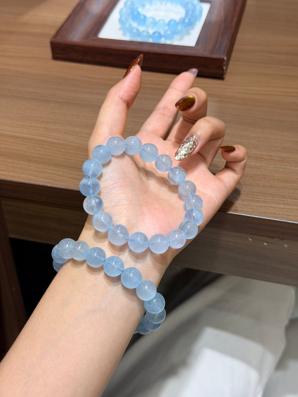 Premium aquamarine bracelet with 12mm beads worn on wrist
