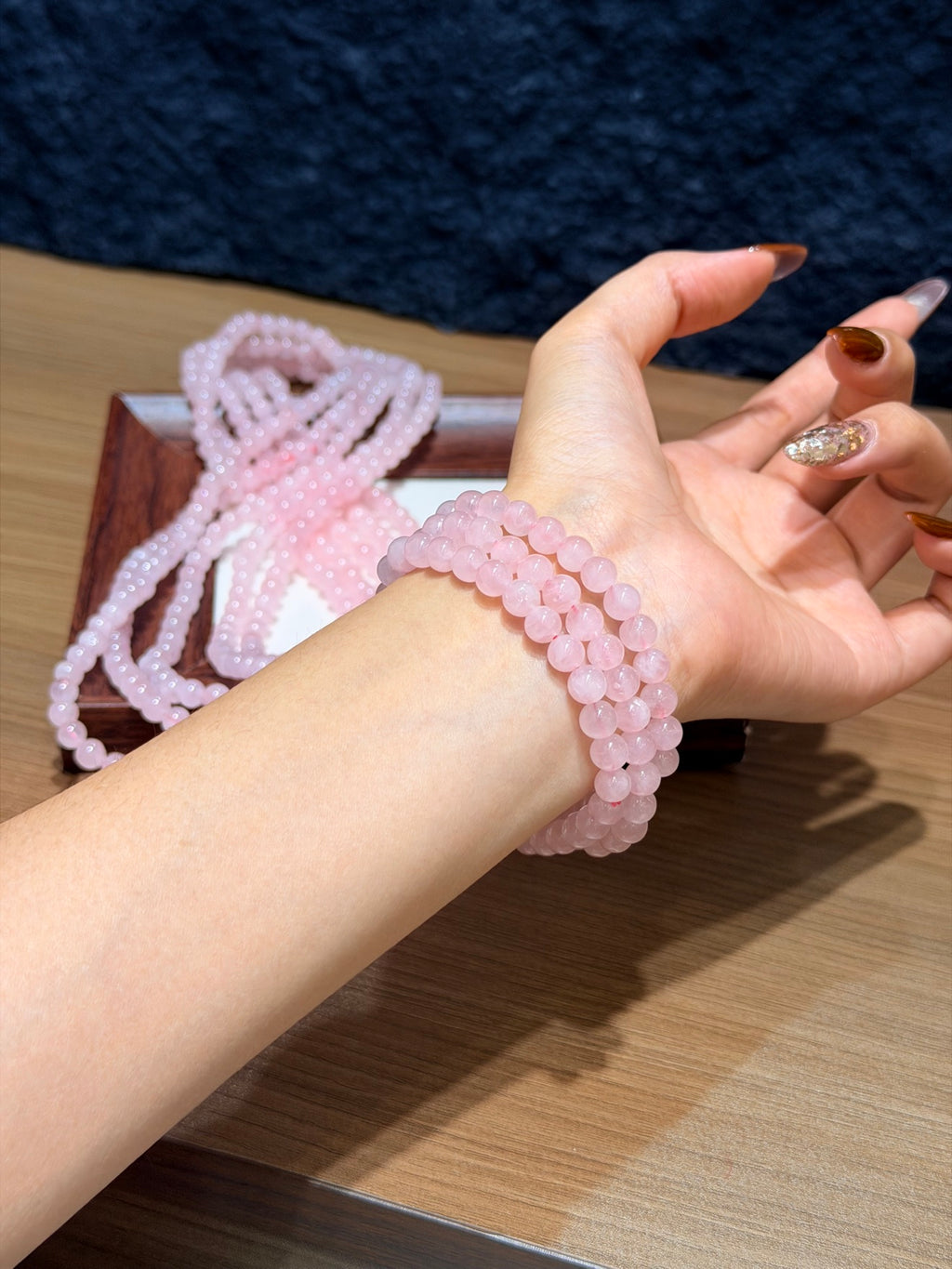 Madagascar pink quartz triple wrap bracelet worn on wrist