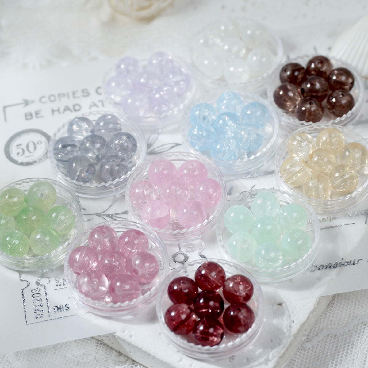 Clear cups holding assorted-color translucent glass round beads