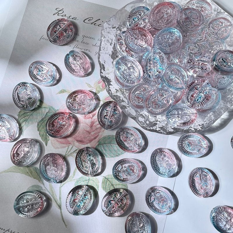 Round engraved glass beads with colorful printed designs on floral paper