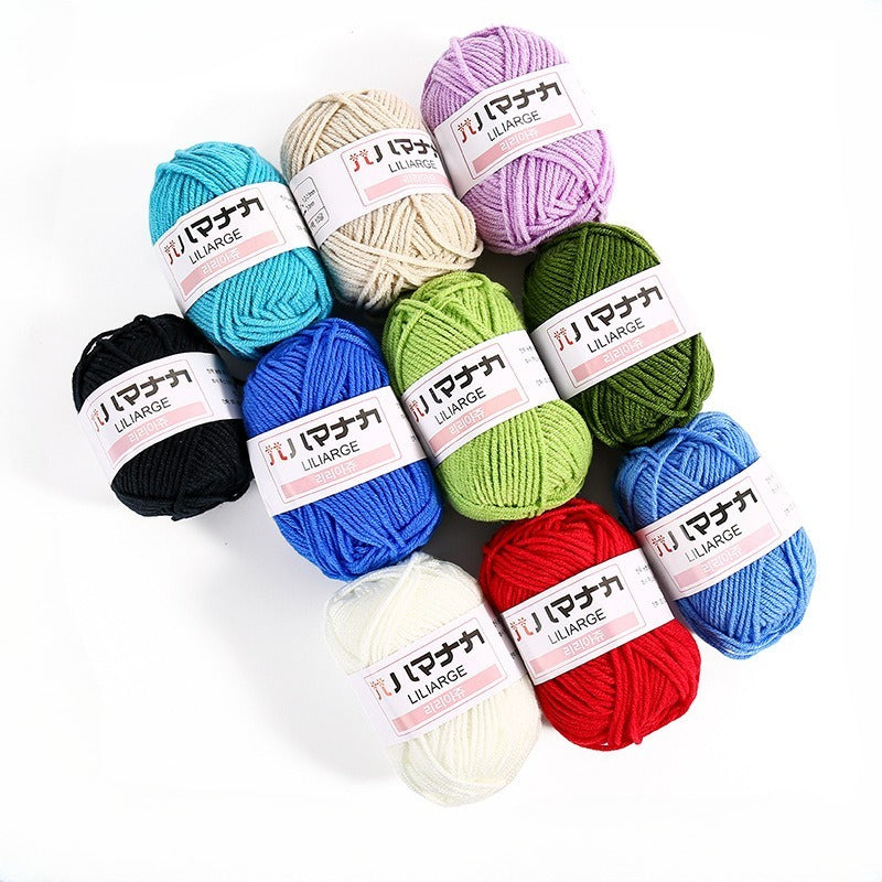 Nine skeins of yarn in assorted colors arranged in a cluster on a white background. Each skein has a paper label with Japanese text and the brand name 'YU MACHINA'.