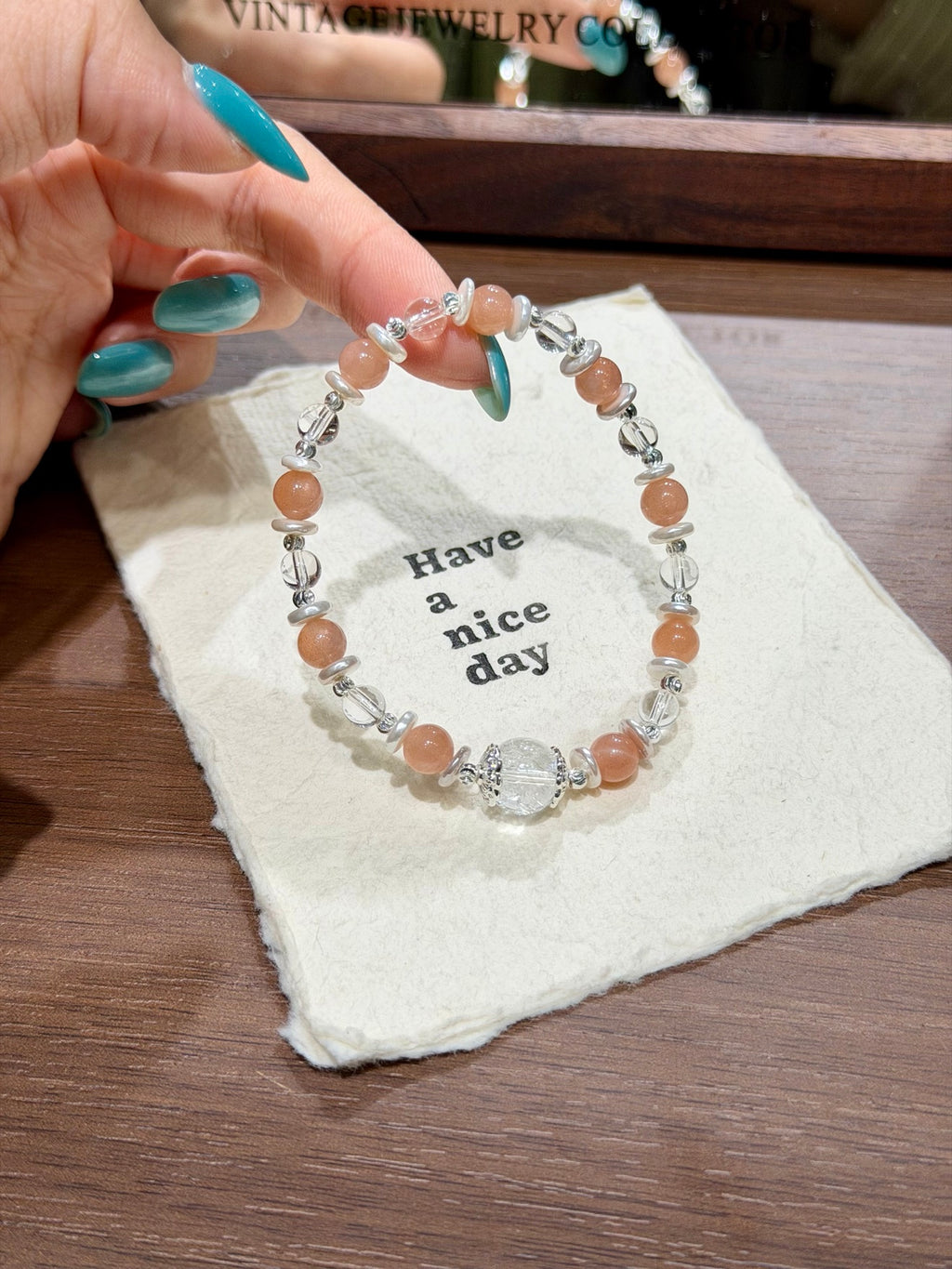 Warm glow bracelet with white agate and shell spacers over card