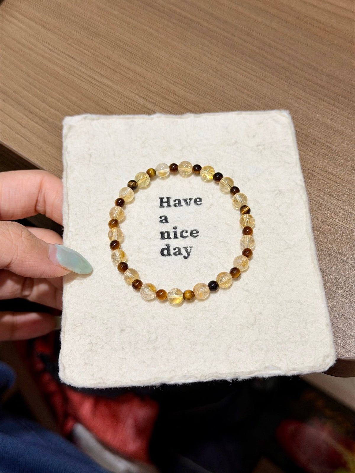 Beaded bracelet with yellow, amber-brown, and dark brown beads