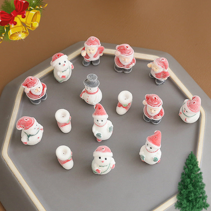 Small Christmas-themed figurines arranged on a gray hexagonal tray