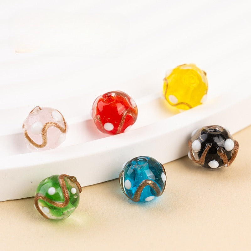 Gold-sand swirl polka-dot glass beads in assorted colors