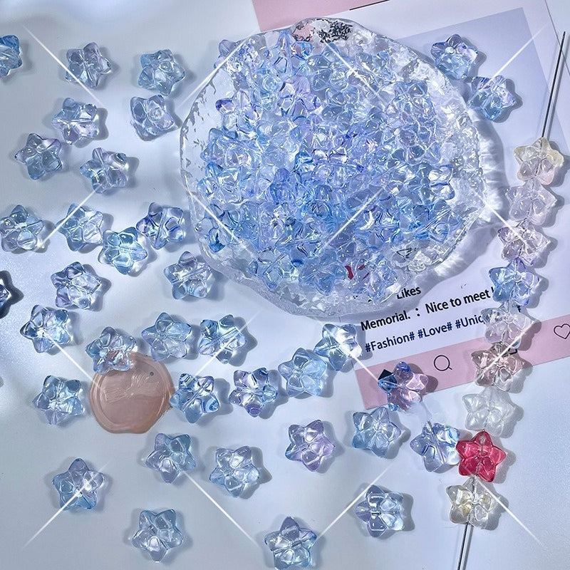 Iridescent star-shaped glass beads in light blue, lavender, and pink with octagonal dish