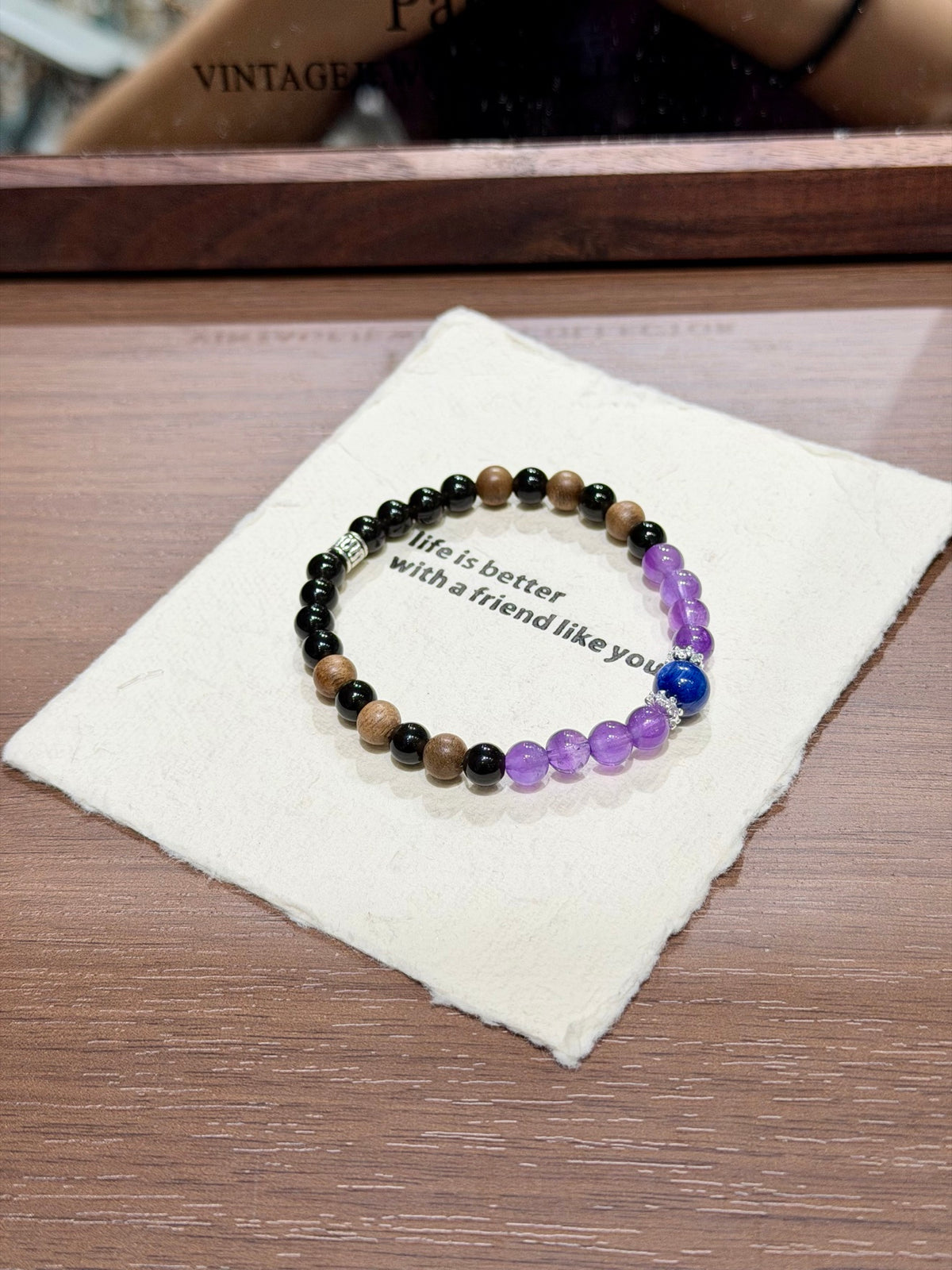 Dusk mountain bracelet with sandalwood and kyanite on card