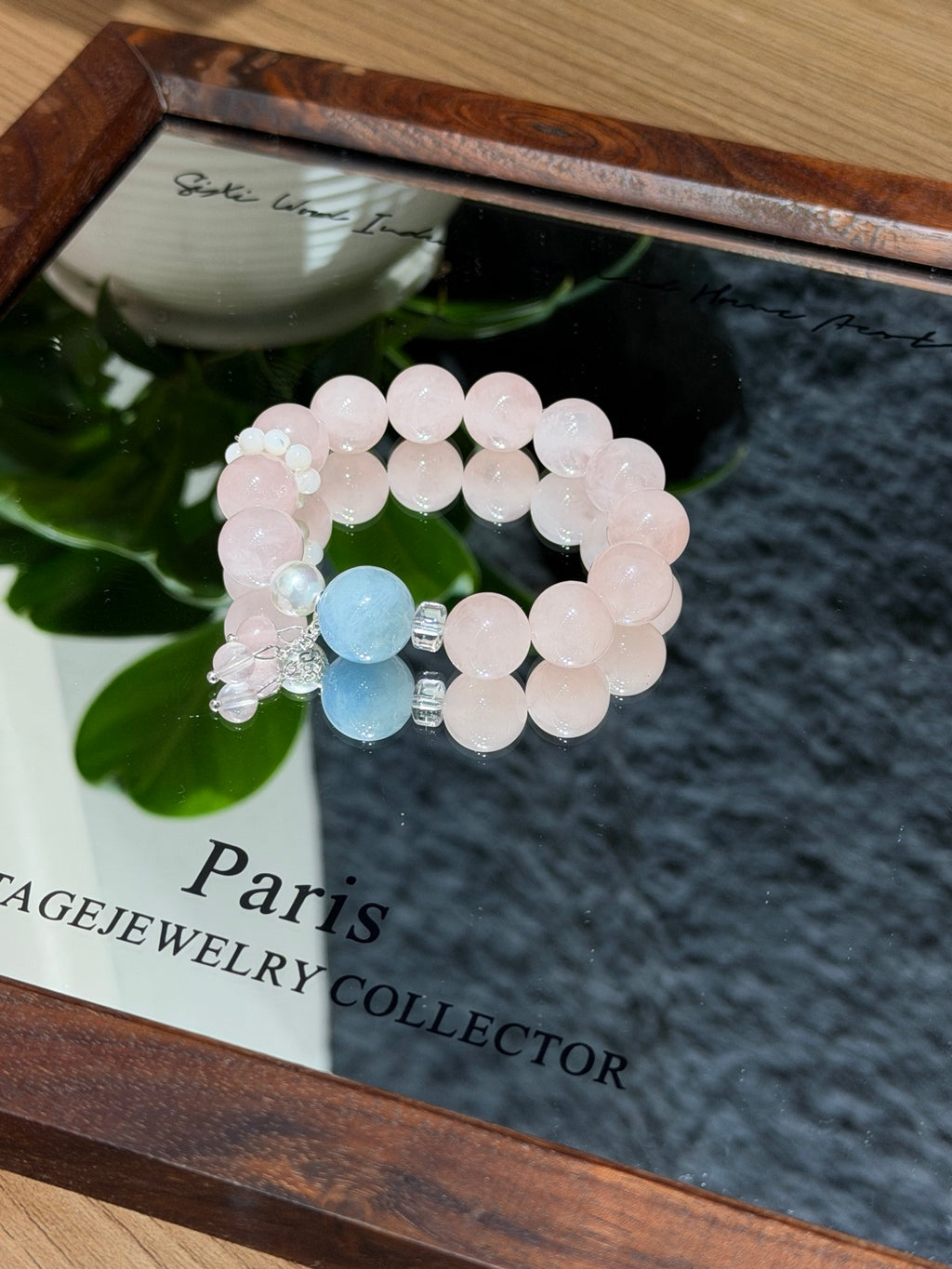 Peach mist bracelet with shell beads on mirror tray