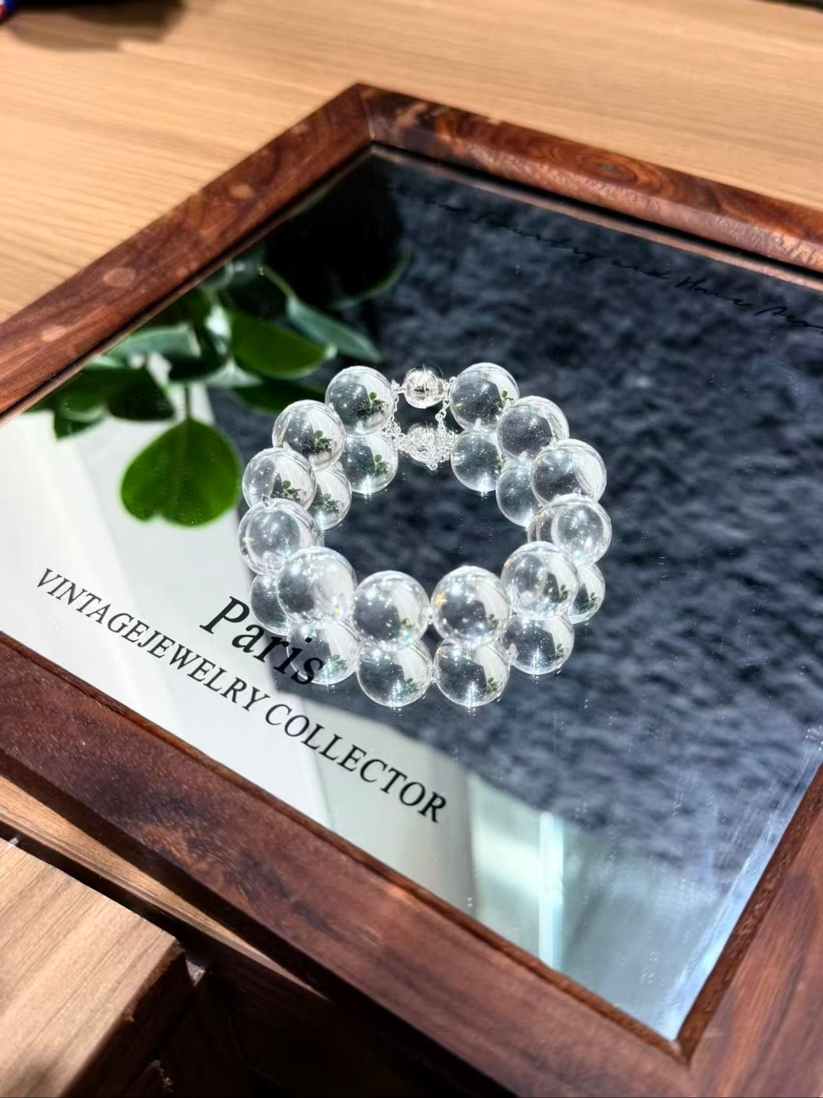 Crystal Bubble Reverie bracelet in a circle on a mirror, showing the full bead layout
