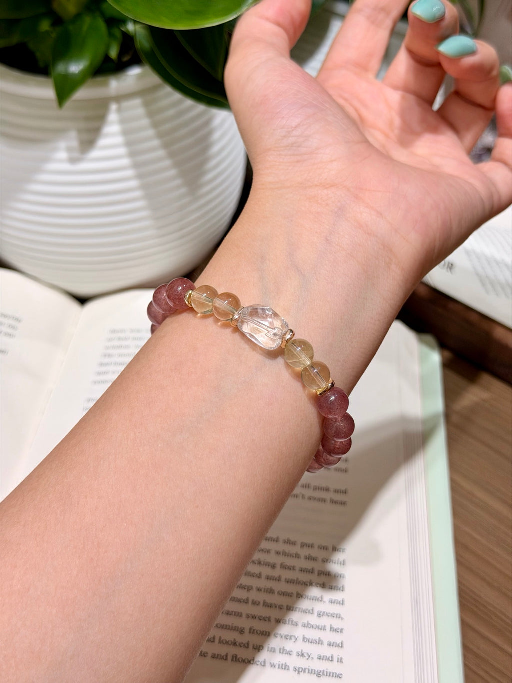 Close-up of strawberry quartz bracelet beads with citrine and gold spacers