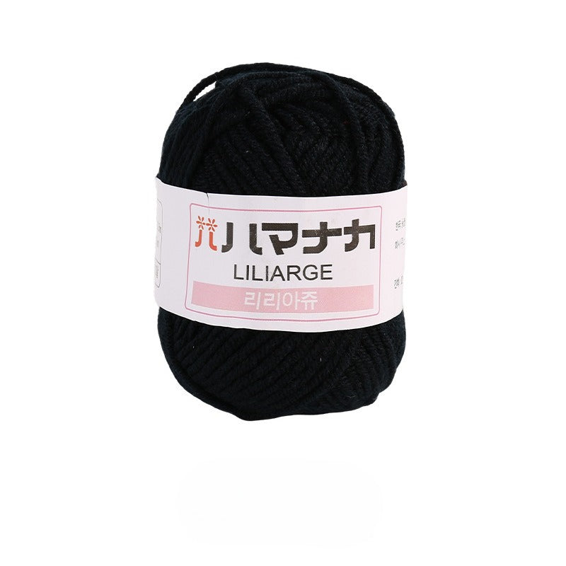 Black 4-ply milk cotton-acrylic yarn skein with white LILIARGE label on white background