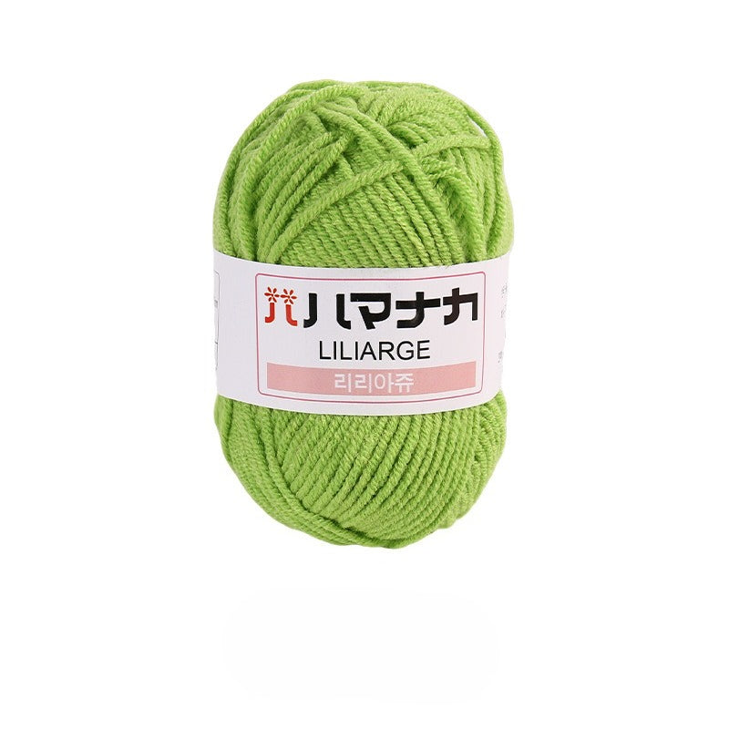 Tender green 4-ply milk cotton-acrylic yarn skein with white LILIARGE label on white background