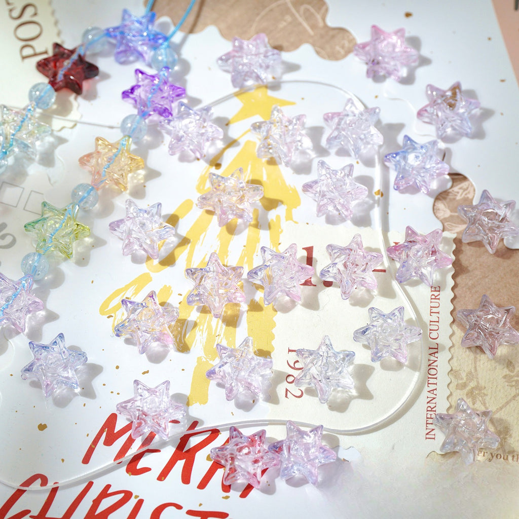 Clear glittery star-shaped glass beads scattered on a decorated Christmas card