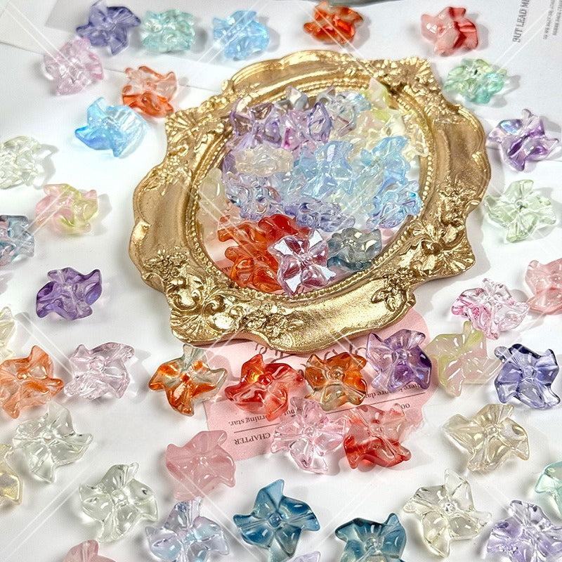 Collection of colorful translucent 20mm carved glass windmill beads around and inside an ornate gold oval frame