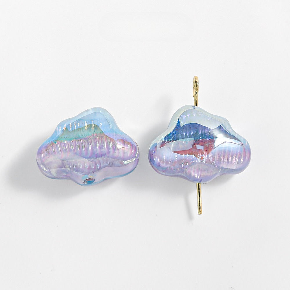 Two iridescent cloud-shaped translucent resin beads, one threaded on a gold eye pin, on a white background.