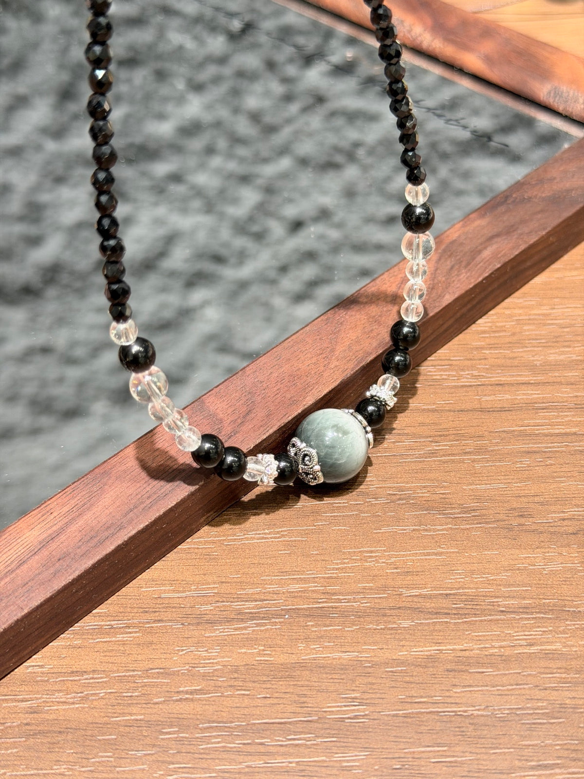 Night Hawk's Eye Necklace focal bead detail on mirror tray