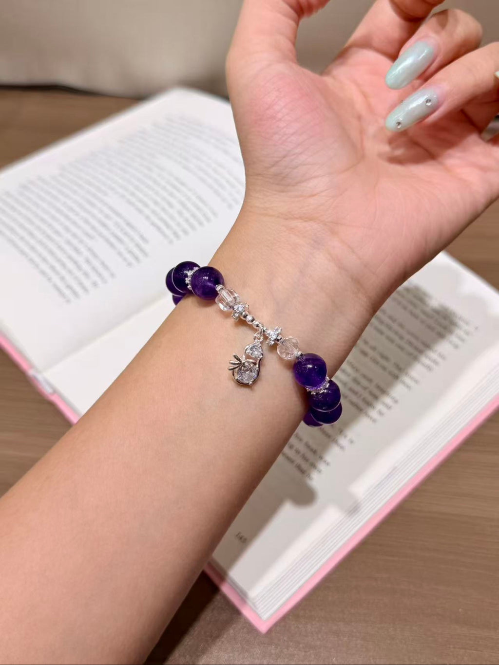Amethyst dream double wrap bracelet with silver charm worn on wrist