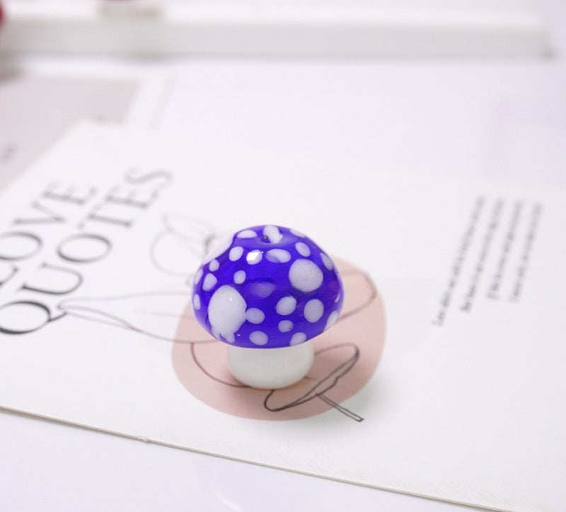 Blue mushroom-shaped glass bead with white spots on a LOVE QUOTES card