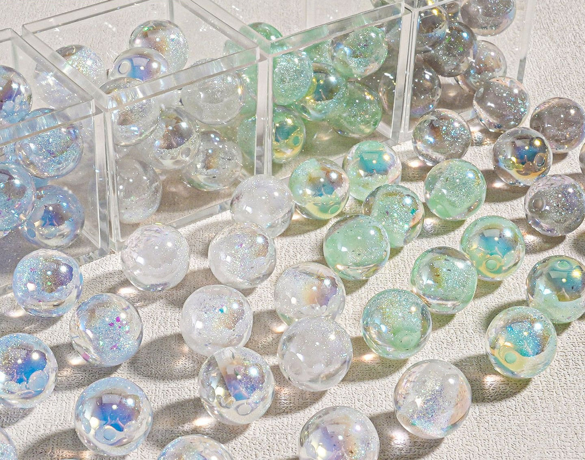 Clear candy-core opal-effect resin round beads with iridescent glitter and pastel reflections