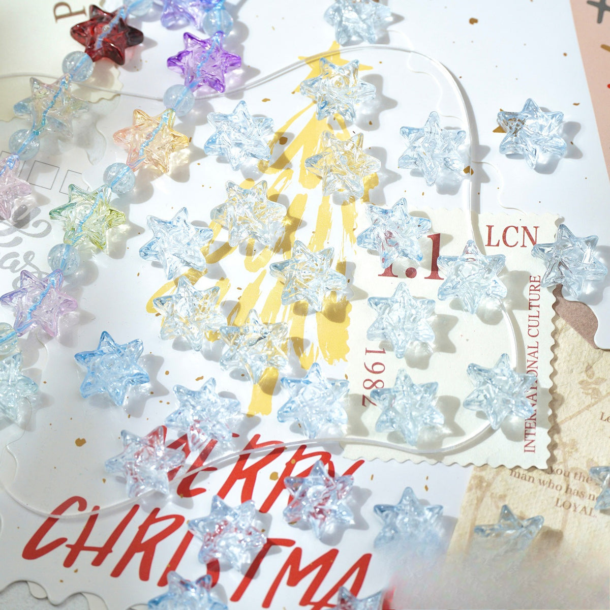 Translucent star-shaped glass beads and garlands in pastel and neon colors on a Christmas card