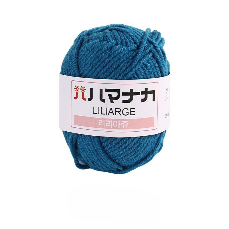 Sapphire teal blue 4-ply milk cotton-acrylic yarn skein with white LILIARGE label on white background
