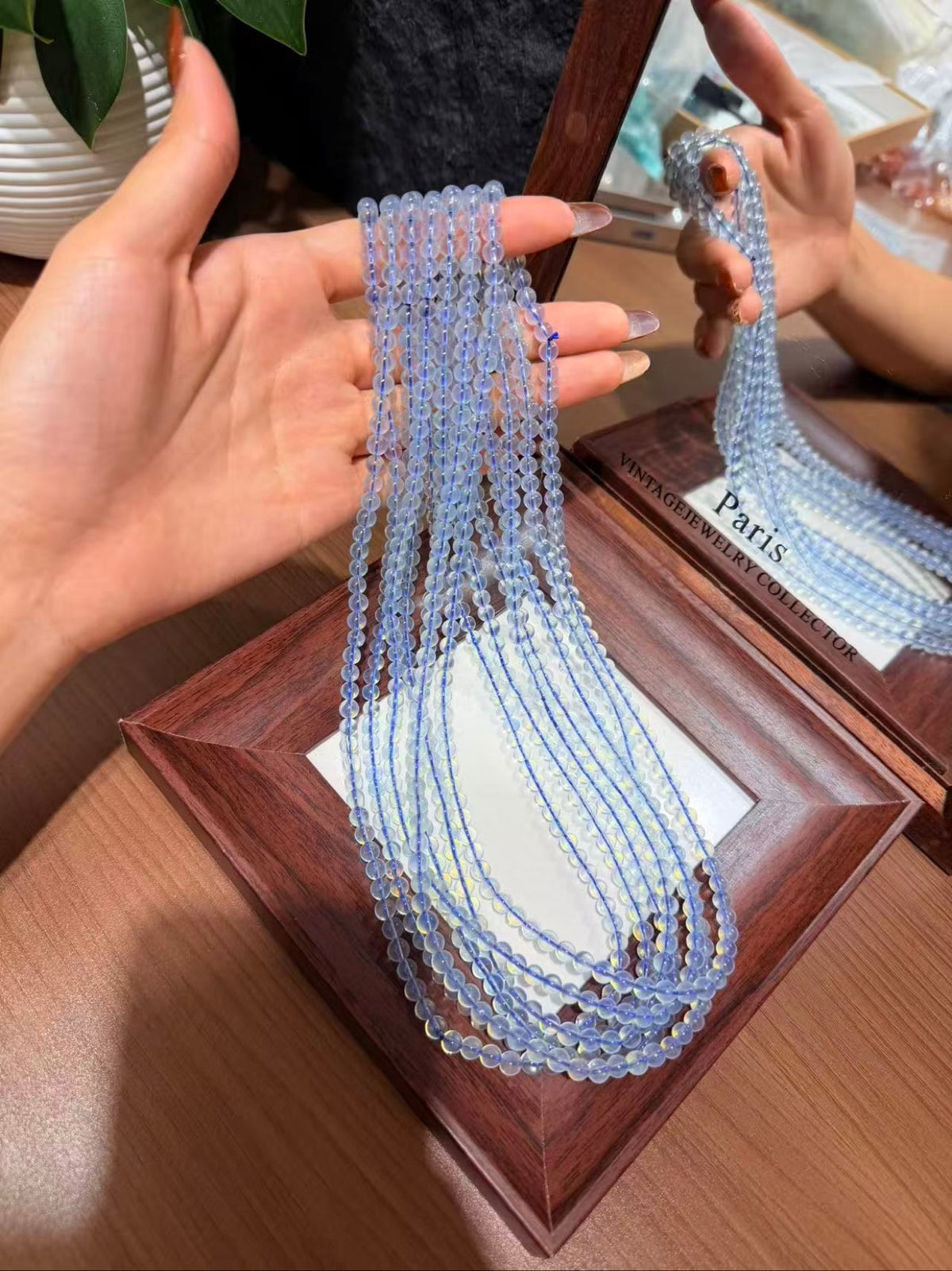 Aquamarine Triple Wrap Bracelet held in hand