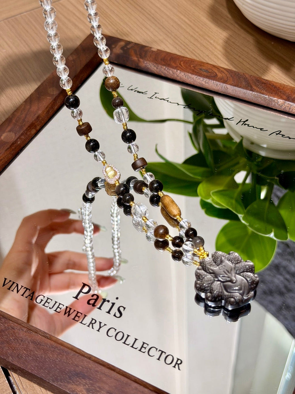 Beaded necklace with carved gray fox pendant, black and clear beads