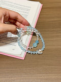 Ocean Starfall double-loop bracelet with aquamarine and white quartz beads worn on wrist