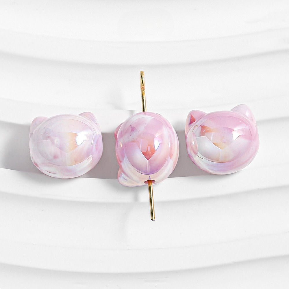 Three pink cat-shaped stud earrings with glossy marbled finish and gold-tone posts.