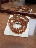 Milk tea moonstone plain strand bracelets coiled on a Thank You card