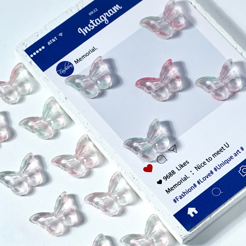 Translucent butterfly-shaped glass beads on a white display card with matching embellishments
