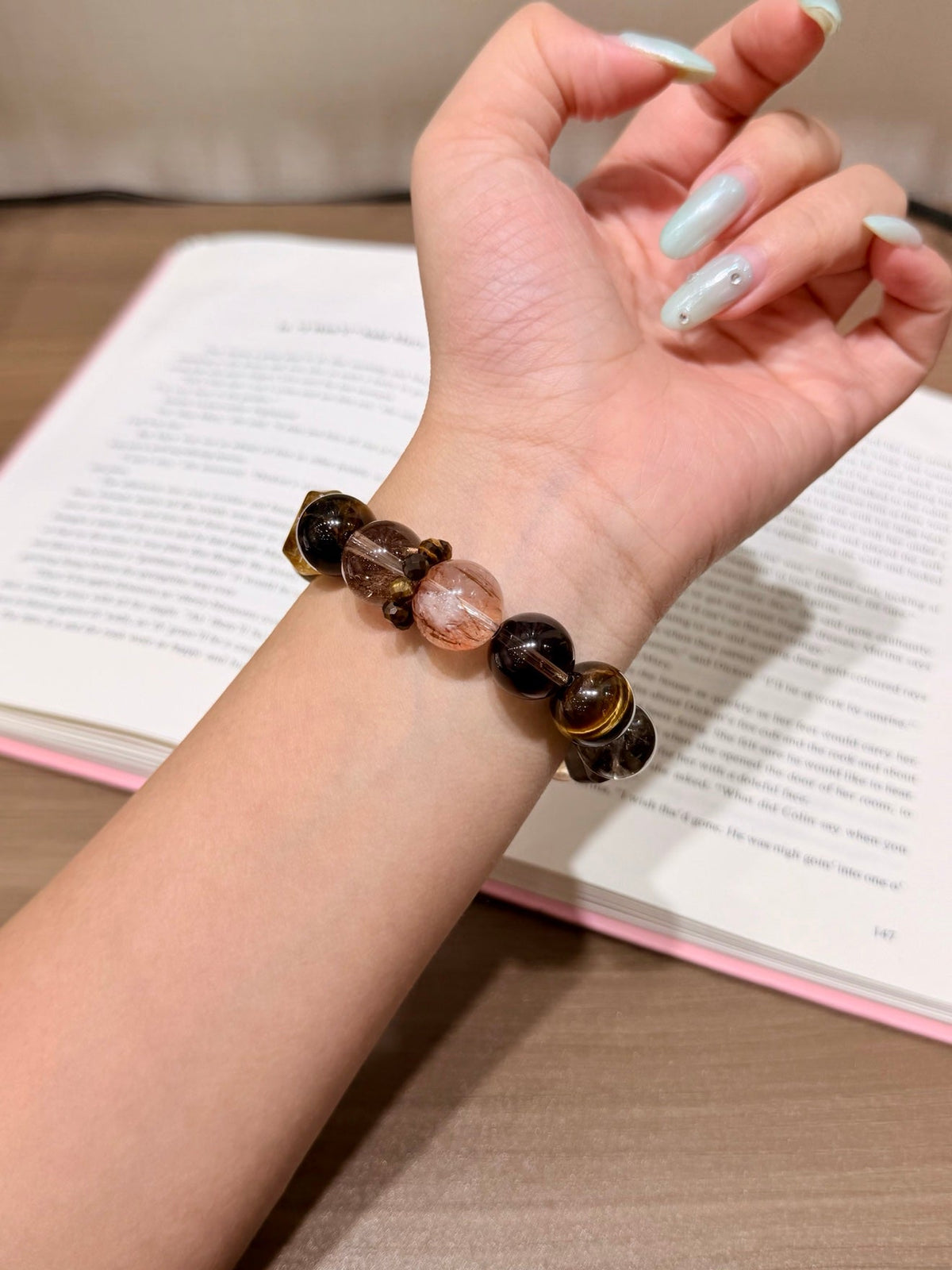 Brown tiger's eye beaded bracelet worn on a wrist
