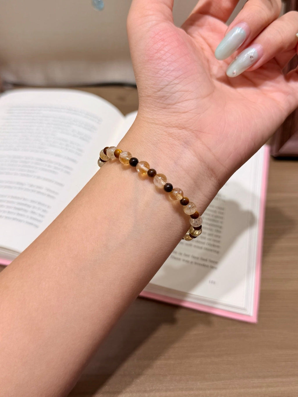 Beaded bracelet with light brown and dark brown beads on a wrist