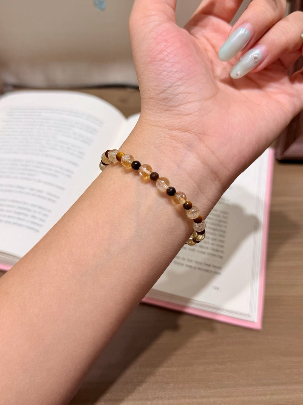 Beaded bracelet with light brown and dark brown beads on a wrist