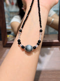 Night Hawk's Eye Necklace draped on wrist