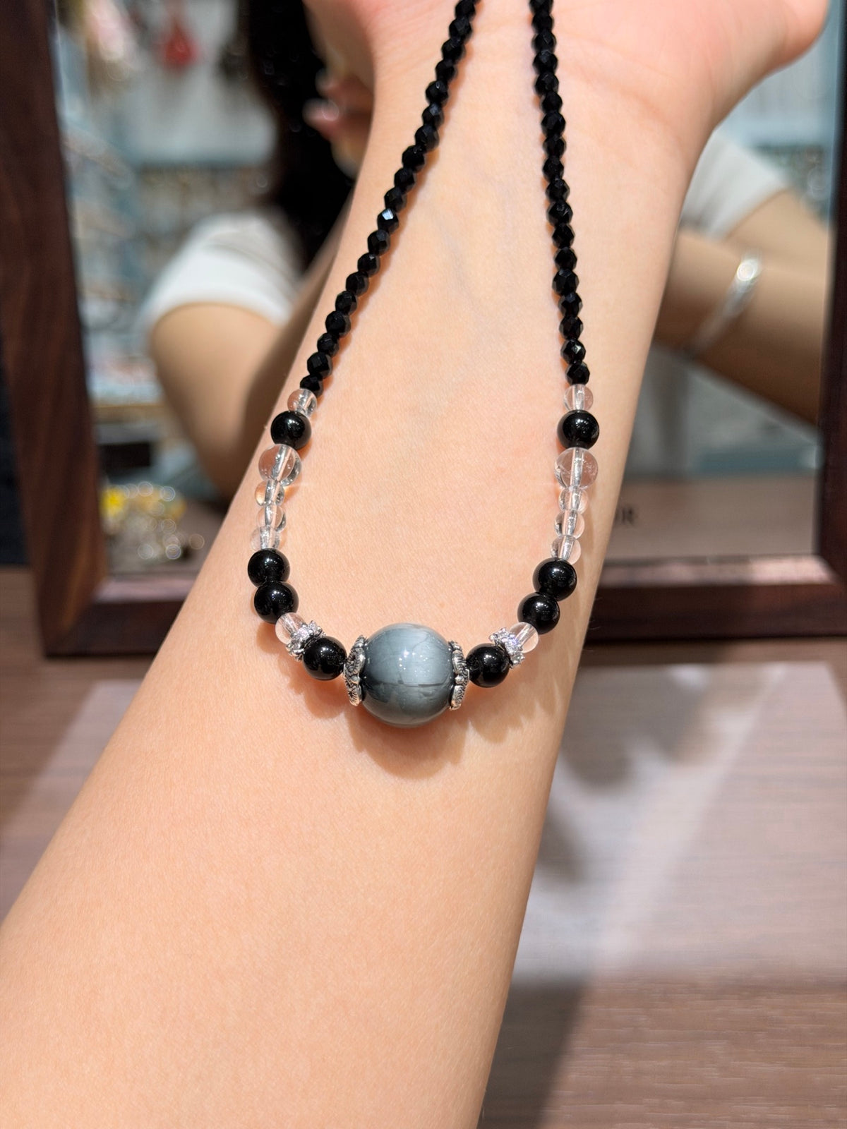 Night Hawk's Eye Necklace draped on wrist