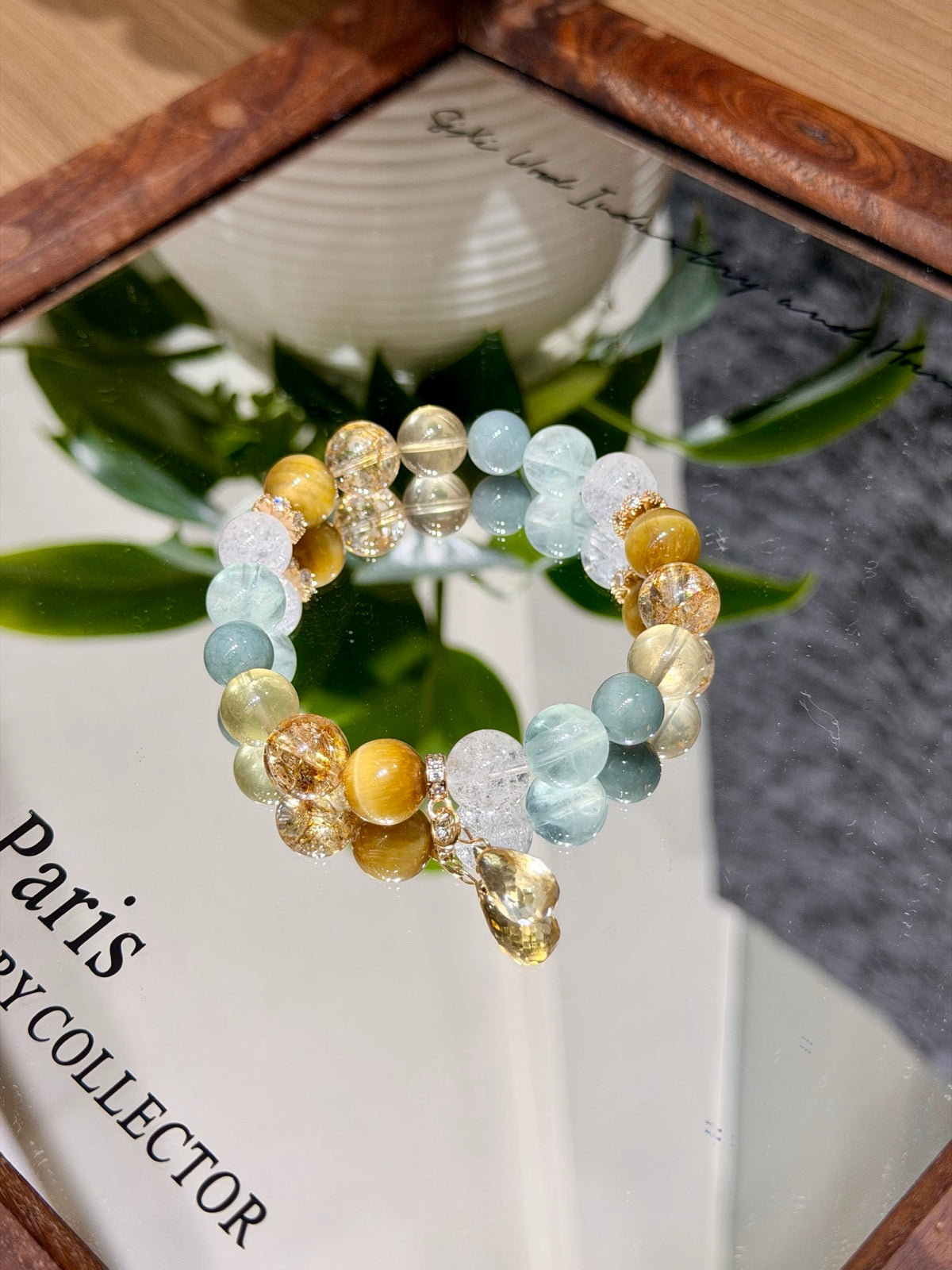 Gilded Dawn multi-stone crystal bracelet with yellow teardrop pendant worn on wrist