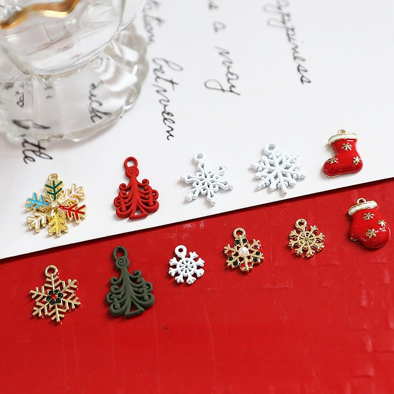 Christmas rhinestone alloy pendant charms including stockings, gloves and snowflakes on red surface