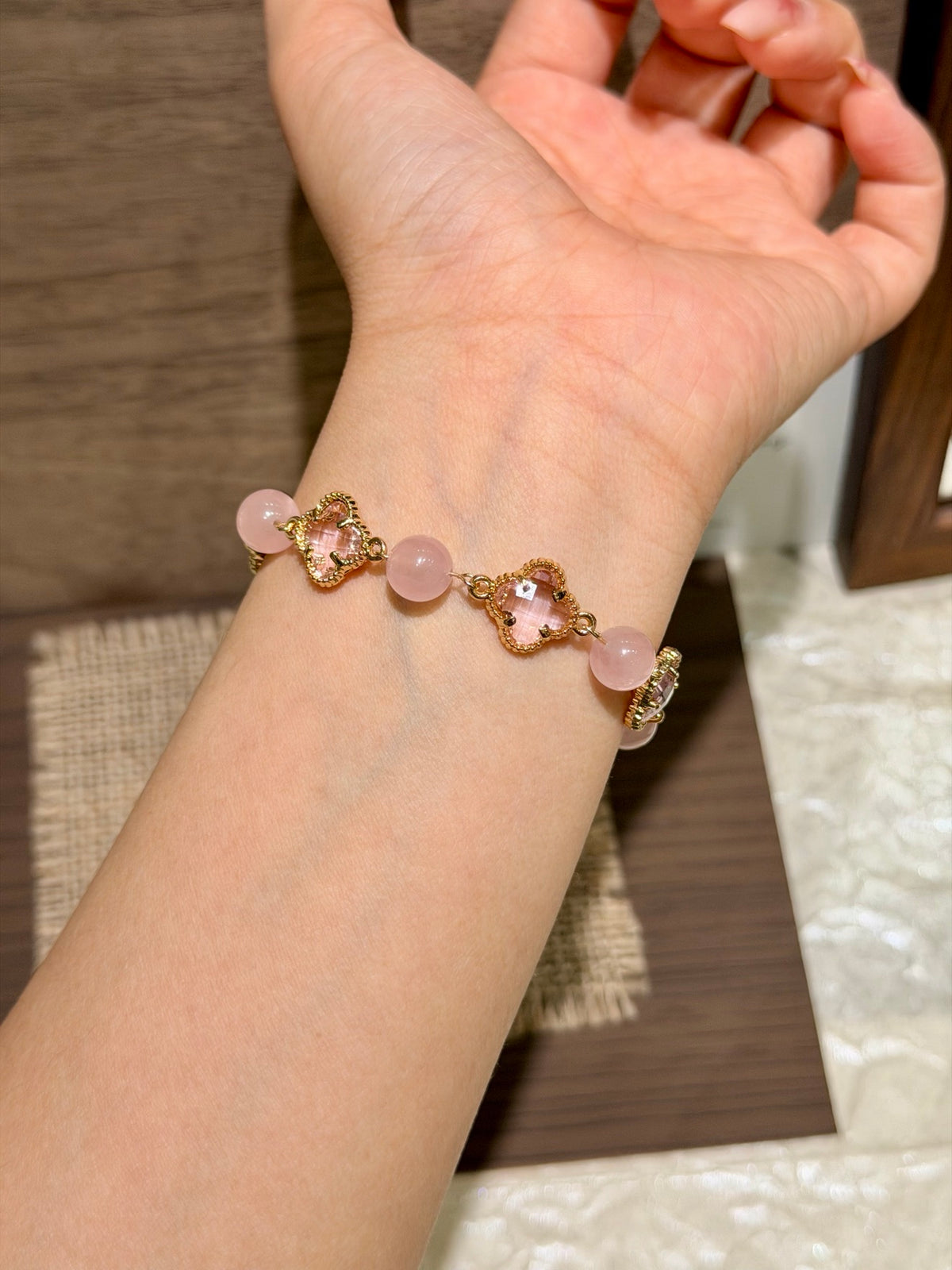 Pink Cherry pink quartz four-leaf clover bracelet on wrist