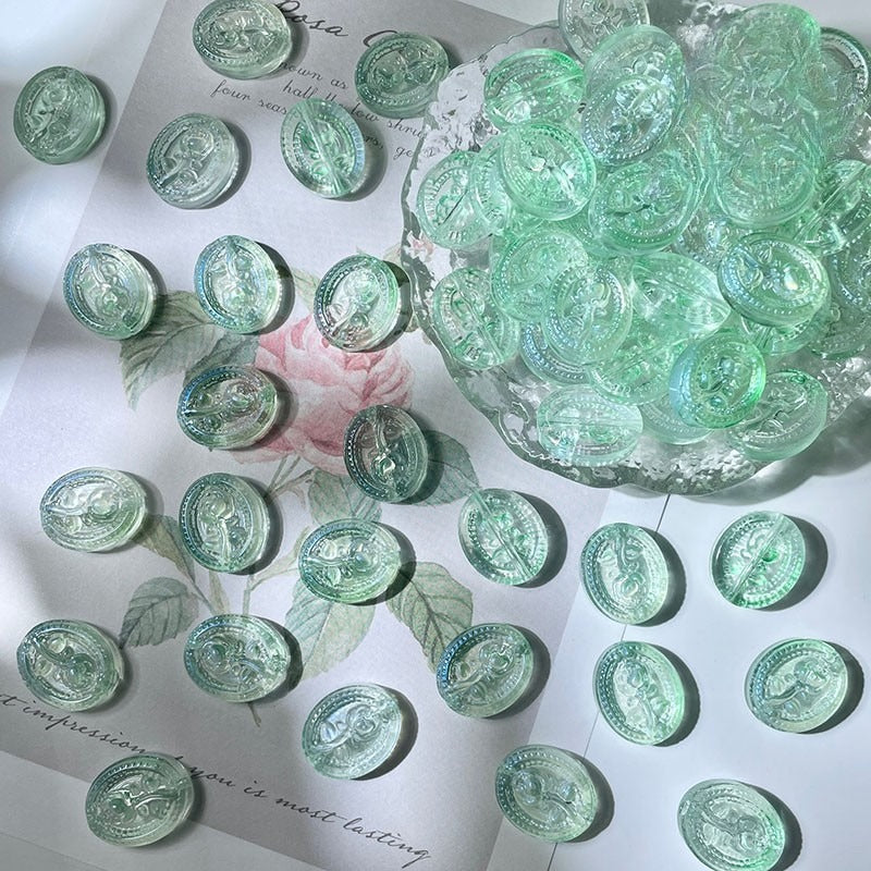 Light green oval engraved glass beads with horse motifs on a card