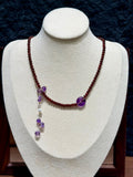 Garnet & Amethyst Peace Buckle Necklace on display bust