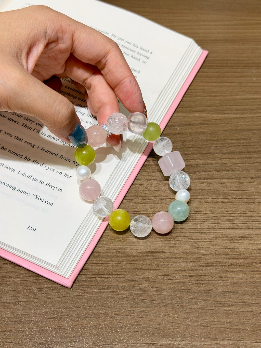 Spring Orchard Bracelet held over open book