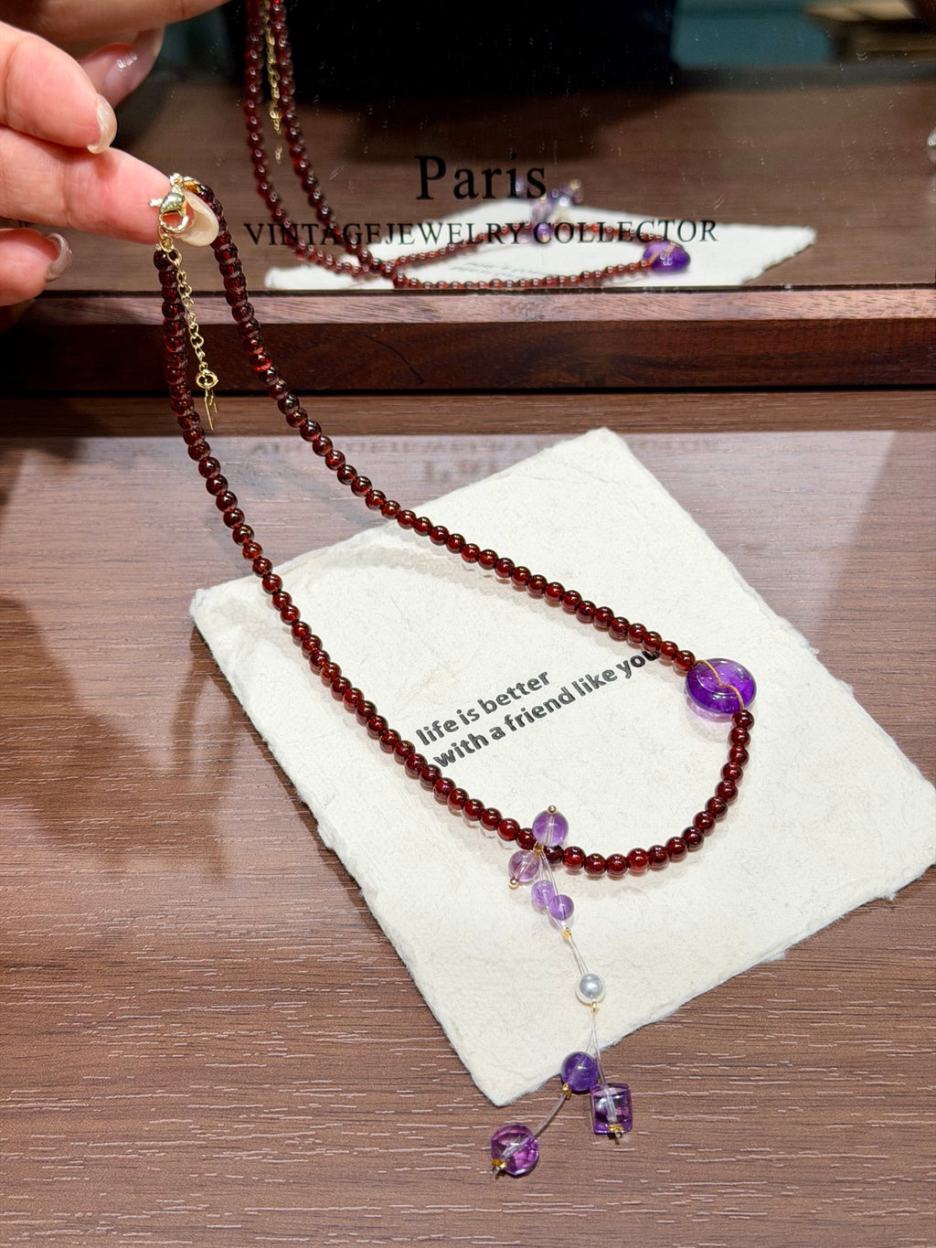 Garnet & Amethyst Peace Buckle Necklace flat lay with clasp