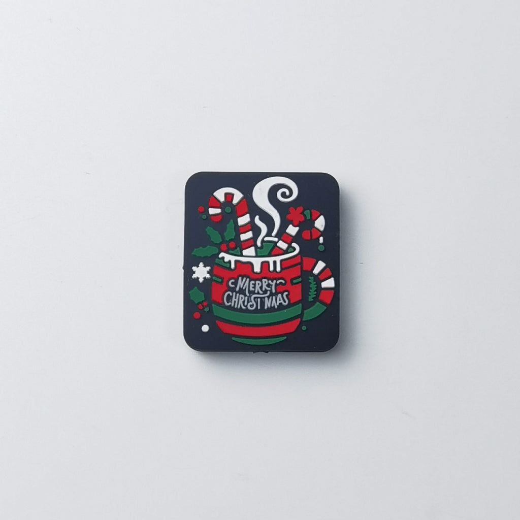 Square dark navy silicone focal bead with red mug, candy canes, holly and 'MERRY CHRISTMAS' text