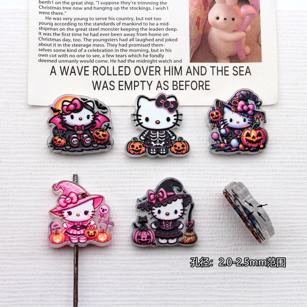 Five Hello Kitty Halloween acrylic charms with witch, skeleton, and vampire costumes on white surface with printed card