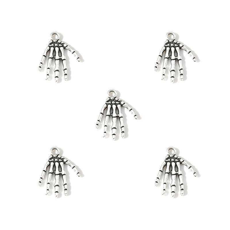 Five silver-toned skeleton hand charms arranged on a plain white background.